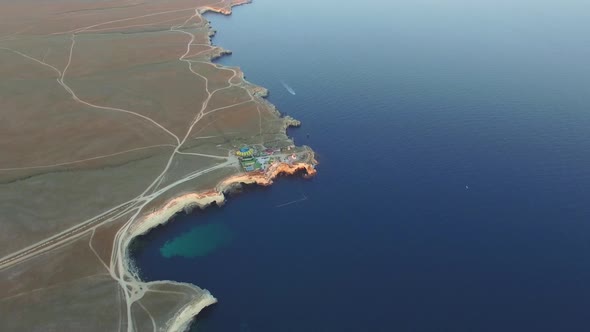 Drone View of the Coastline with Sheer White Rocks at Sunset