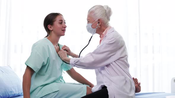 Senior Female doctor checking the symptoms of the woman patient. the concept of health