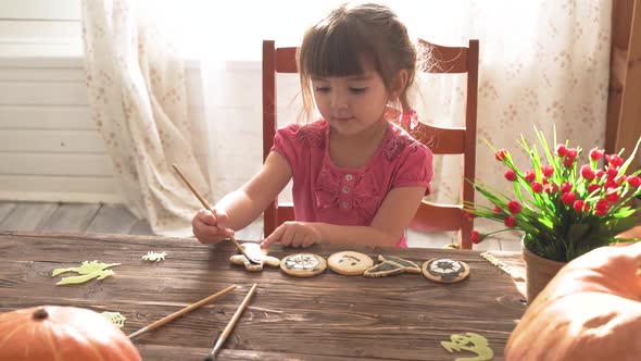 Little Girl Painting Halloween Cookies