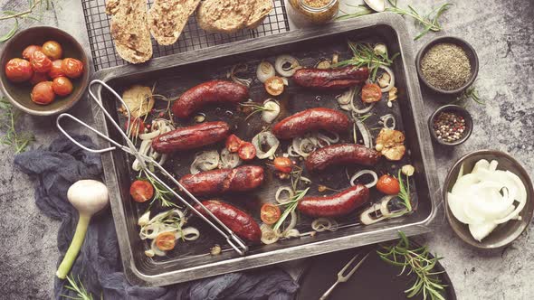 Tasty Grilled Homemade Rosemary Sausages Placed on Iron Frying Tray Over Rustic Dark Stone Table