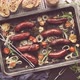 Tasty Grilled Homemade Rosemary Sausages Placed on Iron Frying Tray Over Rustic Dark Stone Table - VideoHive Item for Sale