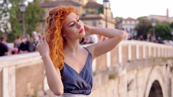 beautiful woman on Lungotevere laughs arranging her hair- beauty, youth