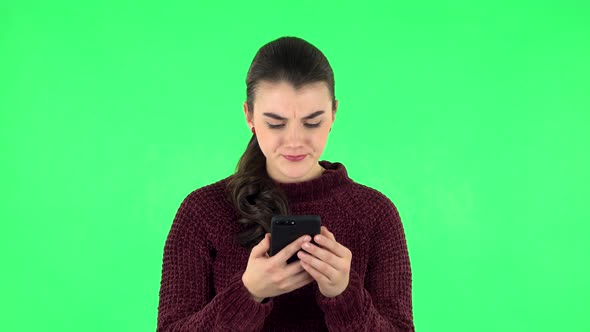 Girl Angrily Texting on Her Phone. Green Screen