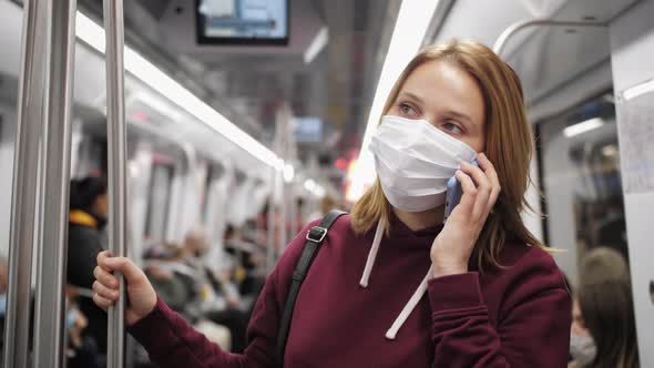 Passenger Wearing Protective Mask Having Phone Conversation on Metro Subway