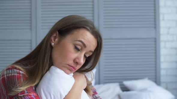 Upset Lonely Woman Hugging Pillow in Problems