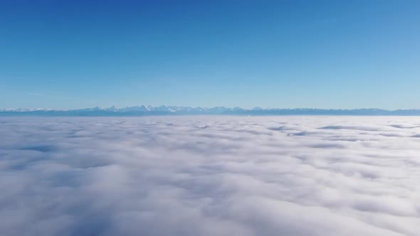 wonderful flight with the drone over a breathtaking sea of ​​fog towards the majestic swiss alps in