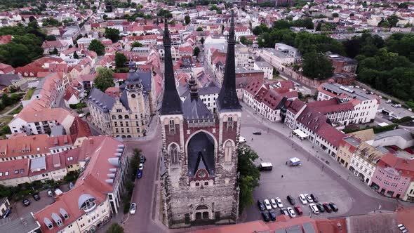 high aerial view of St. Jakob church during cloudy day, rotating drone shot