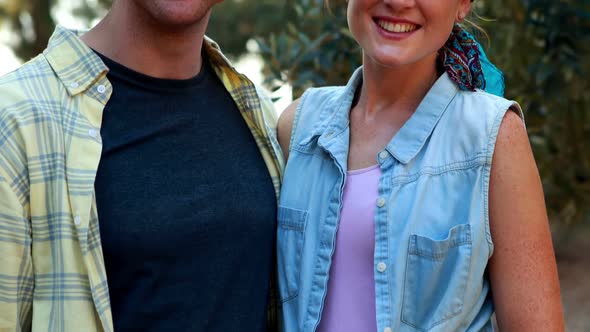 Smiling couple standing in olive farm