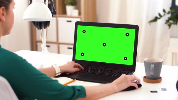 Woman with with Green Screen on Laptop at Home