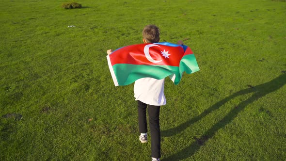 Child waving the flag of Azerbaijan.