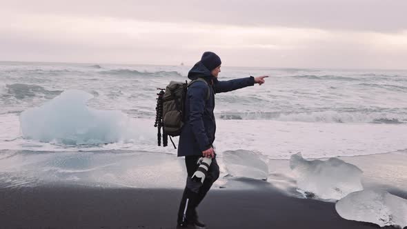 Photographer Walking Along Diamond Beach in Iceland