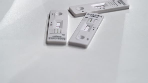 Tilt up to three completed COVID Antigen Rapid tests on white surface