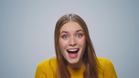 Portrait of Positive Woman Showing Thumbs Up at Camera on Grey Background