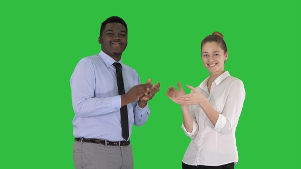 One businessman and one businesswoman applauding on a Green