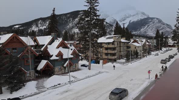 Wide view Banff avenue covered in snow, Mountains in distance, Ski town. Canadian Landscape