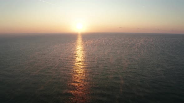 Aerial video over the morning calm sea and beautiful sunrise