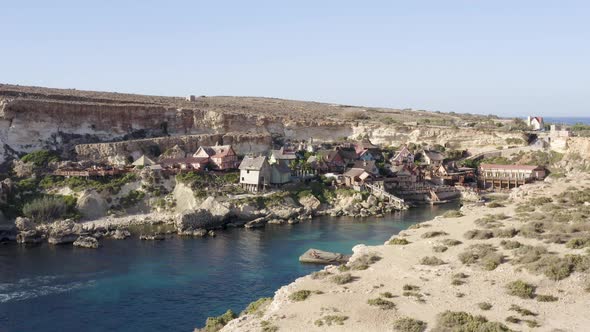 Popeye village theme fun park in sunny Prajjet bay,Malta,aerial zoom.