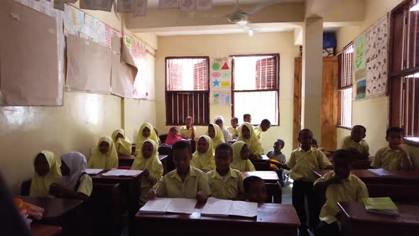 Children in an African Elementary School Sit at Desks in a Classroom Zanzibar