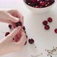 Lady hands take delicious red cherry and remove stem - VideoHive Item for Sale