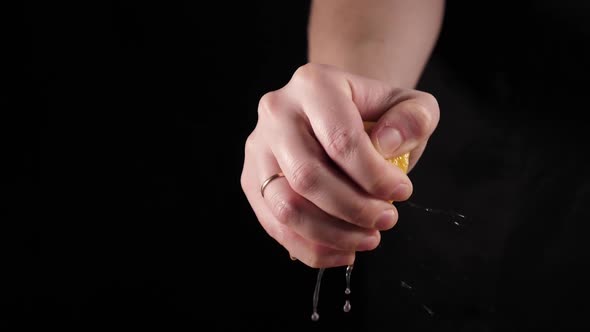 Citrus fruit - squeezing a lemon by hand