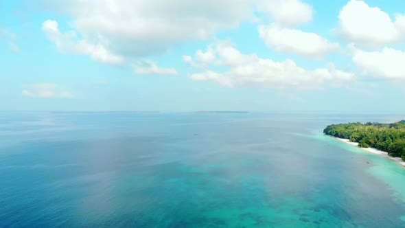 Aerial: flying over white sand beach tropical sea Kei Islands Maluku Indonesia