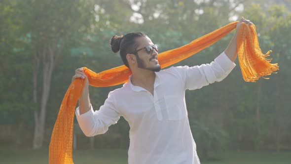 Indian man dancing openly in an Indian traditional outfit Kurta pajama