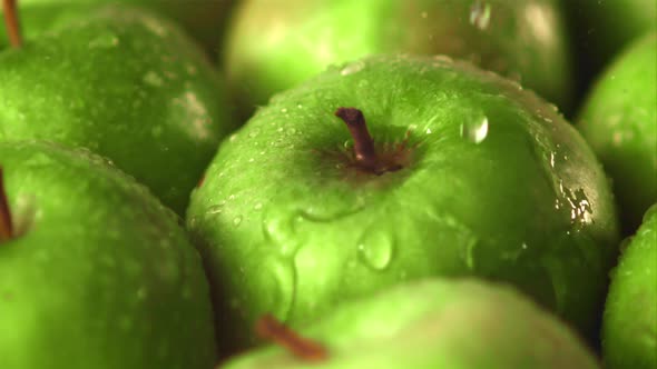 Super Slow Motion Water Droplets Fall on Green Apples