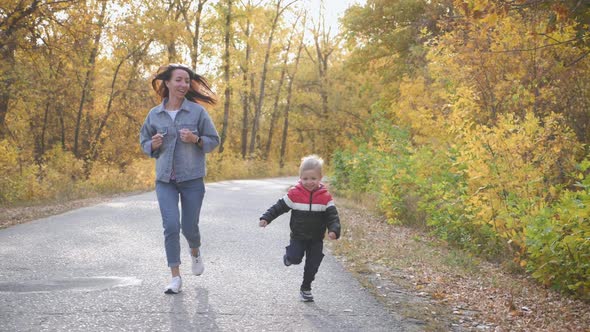 Cute Little Boy and Mother During the Walk in Nature