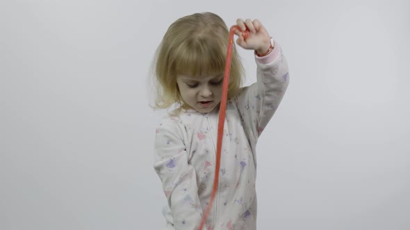 Kid Playing with Hand Made Toy Slime. Child Having Fun Making Pink Slime