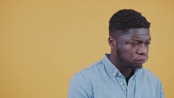 African American Man Making a Hard Decision Moving His Hands Horizontal Portrait Isolated Yellow