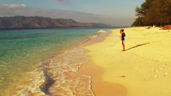 Boy angling on perfect sea view beach voyage by clear sea with white sand background of Gili Trawang