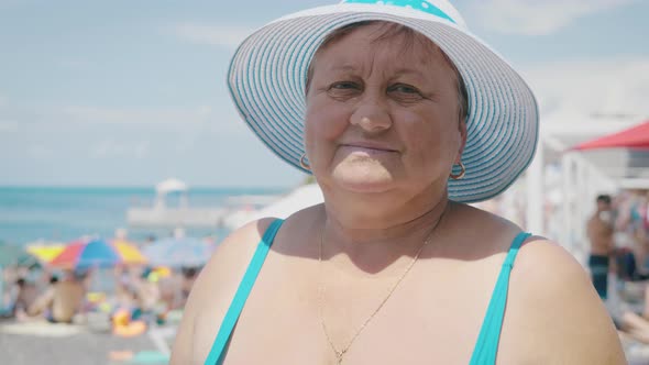 Attractive Middle Aged Woman on the Beach. Age, Leisure and People Concept. Close Up of Happy Senior