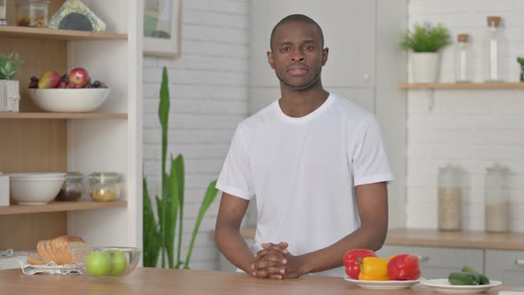 Sporty African Man Looking at the Camera While Standing in Kitchen