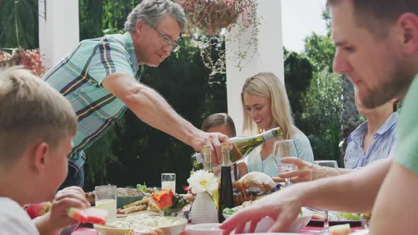 Happy family eating together at table