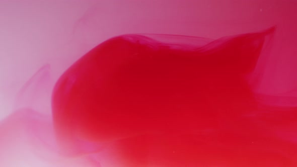 Red ink dissolving in water