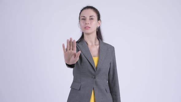 Serious Young Businesswoman Showing Stop Gesture