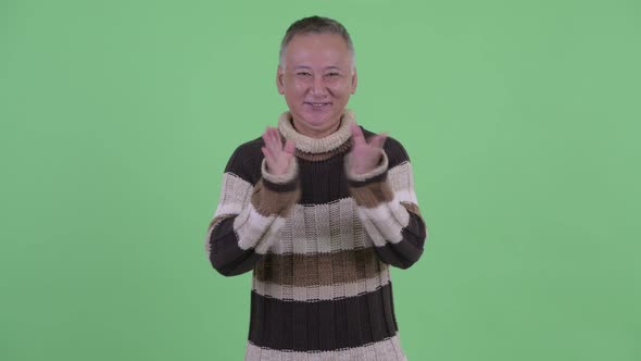 Happy Mature Japanese Man Clapping Hands While Looking Excited