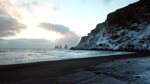 Reynisdrangar Sea Stacks Iceland in the winter aerial drone 4k