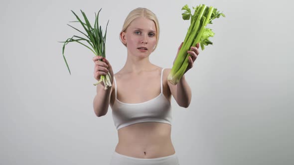 Pretty Young Woman Holding Green Leaves Recommending Vegan Natural Food