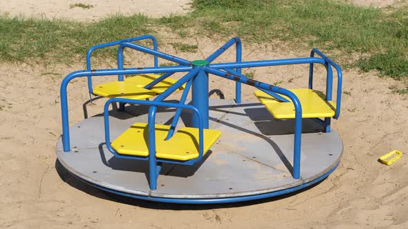 4K - Empty carousel spinning on the playground