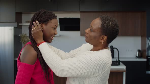 Black Mother Encouraging Teenage Daughter Indoors