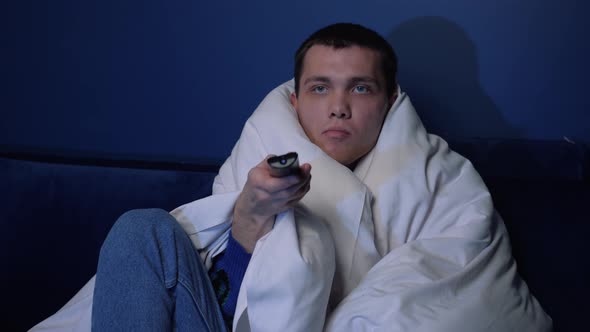 Young Caucasian Man Relaxing Cozy Couch Blanket Choosing Online Film Movie Watching Show