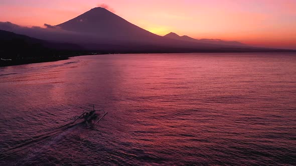 Mt. Agung, Bali, Indonesia - A Majestic Scenic Attraction Of A Volcano With Fisher Boat Traversing T