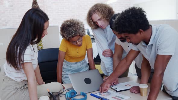 Group of Young Multiethnic Entrepreneurs Works As a Team in the Office