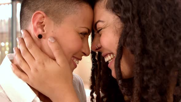 Happy lesbian couple smiling face to face