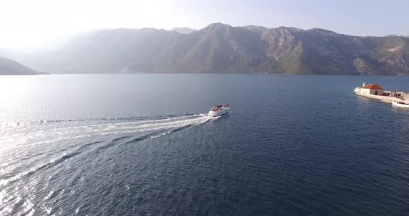 White Yacht Sails on the Sea Past the Island of Gospa Od Skrpjela