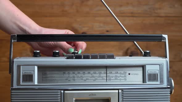 Girl's Hand Twists and Presses the Buttons on the Retro Radio Tape Recorder