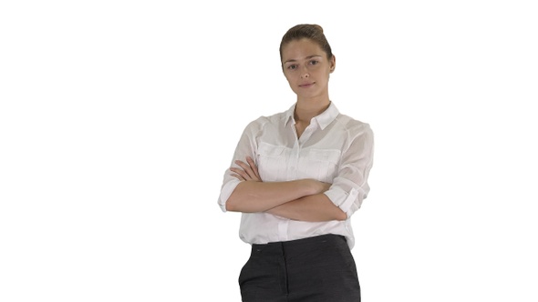 Beautiful young woman in formal shirt crossing arms on