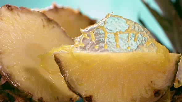 Slow Motion Shot of Pineapple and Juice Splashing Through Pineapple Slices