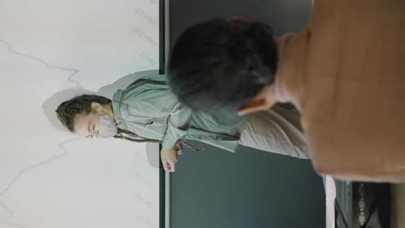 Vertical Shot of Businesswoman Giving Financial Presentation